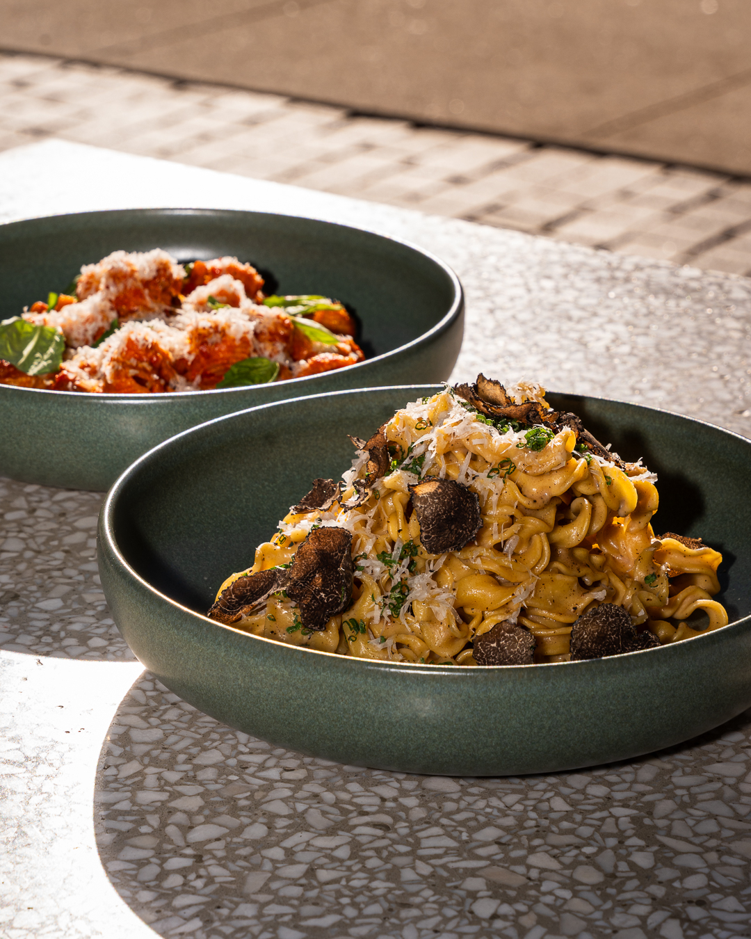Truffle tagliatelle with shaved black truffle and parmesan, alongside rigatoni alla vodka
